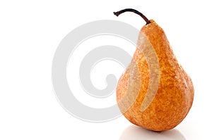 A pear on a white reflective surface