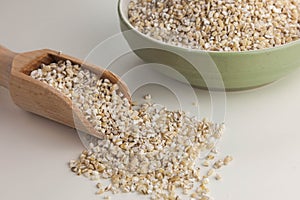 Pearl barley in the bowl isolated on the white background