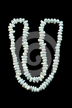 Pearl beads gemstone on black background.