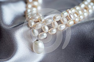 Pearl beads, luxury pendant, necklace closeup.