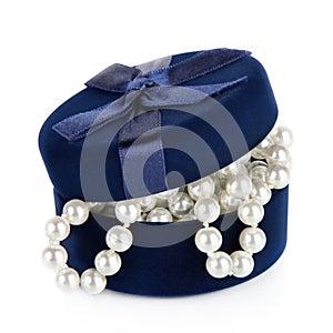 Pearl beads in the slightly opened casket on white