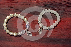 Pearl bracelet custom jewelry on the wood or stone background.