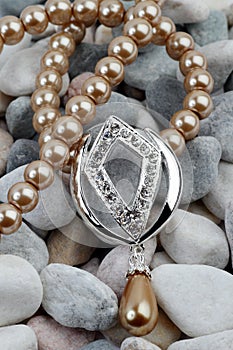 Pearl, diamond jewelery on stones photo