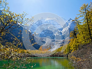 Pearl Lake or Zhuoma La Lake and snow mountain in autumn