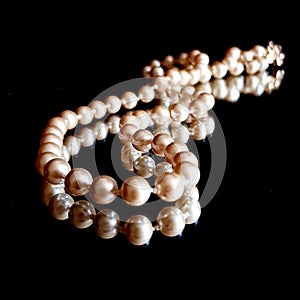 Pearl Necklace on black background with mirror reflection. Classic Jewellery