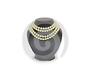 Pearl necklace on black mannequin isolated