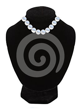 Pearl necklace on black mannequin isolated over white