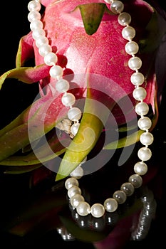 Pearl necklace and dragon fruit
