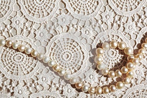 Pearl necklace on lace fabric