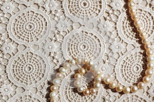 Pearl necklace on lace fabric