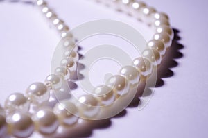 Pearl necklace. Several pearl necklaces on a white background. Women`s jewelry. Luxury and wealth. Costume jewelry and jewelry