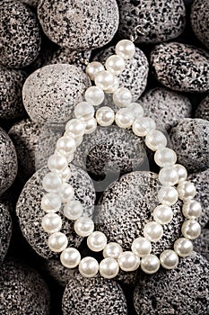 Pearl necklaces on grey stones