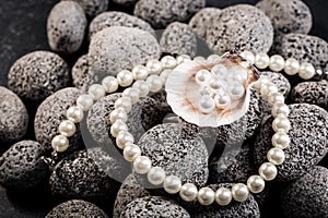 Pearl necklaces on grey stones