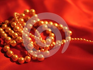 Pearl necklace jewelry on red satin background for valentines day