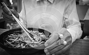 Pearl rings on the finger of a woman who ate Japanese noodles