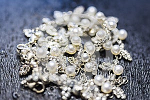 Pearl silver necklace Lying on a dark background photo