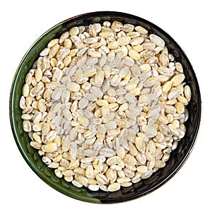 Pearled barley grains in round bowl isolated