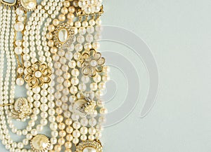 Pearls background. Woman`s Jewelry. Vintage jewelry background. Beautiful gold tone and pearls brooches, braceletes, necklaces an