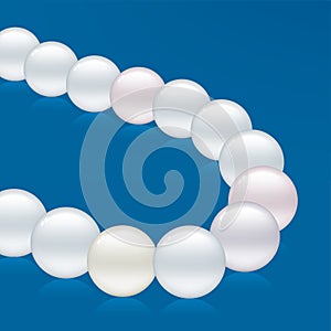 Pearls necklace isolated over blue background. Soft colors