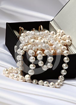 Pearls and rings in black jewelry box