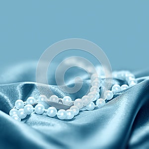 Pearls on a silk fabric background