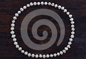 Pearls string circle shaped top view old wood