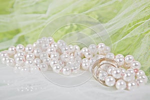 Pearls, wedding rings and bouquet