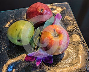 Pears, an Apple, and Orchids on a Glass Plate