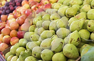 Pears, apples and plums on display at a farmer`s market. Fruit background. Healthy eating. Fall harvest agricultural