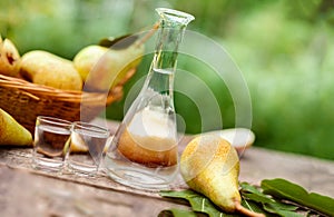 Pears and bottle with pear brandy