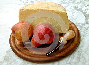 Pears and cheese on a wooden tray