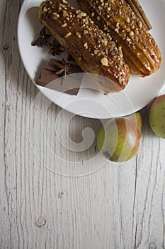 Pears and creampuffs on wooden background