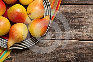 Pears on the dish and cloth on the old wood backing