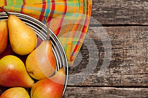 Pears on the dish and cloth on the old wood backing