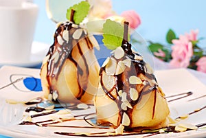 Pears with flaked almonds and chocolate sauce photo