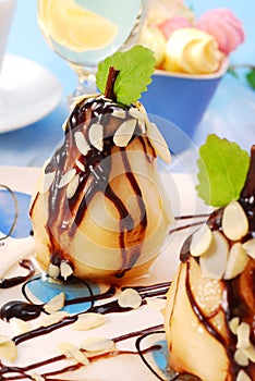 Pears with flaked almonds and chocolate sauce photo