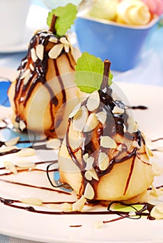 Pears with flaked almonds and chocolate sauce photo