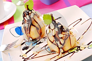 Pears with flaked almonds and chocolate sauce photo