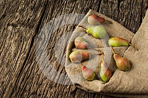 Pears, green pear fruit on a linen sack. Flat lay background.