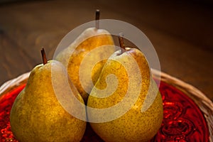 Pears on red dish