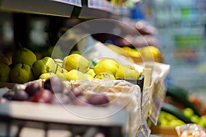 Pears on the shelves of a grocery store. Sale of fresh fruit. Selective focus