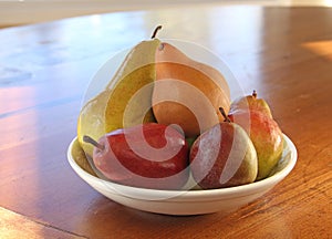 Pears in a white bowl on Wooden Table