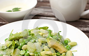 Peas, arugula and avocado salad with creamy dressing