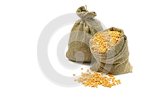Peas in a bag, isolated on a white background.Split peas in burlap. Healthy food.Yellow split peas in a jute bag.Selective focus