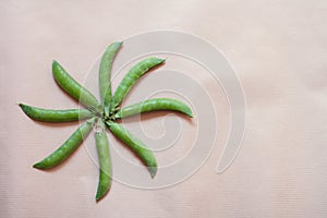 Peas pods on craft paper background