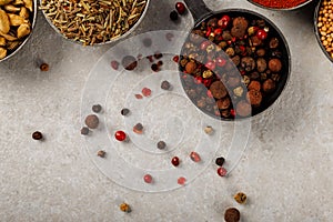 Peas of red and black pepper on the table.