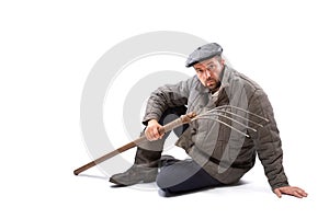 Peasant man with pitchfork on white background, serious concentrated look. Concept - hard life of peasant