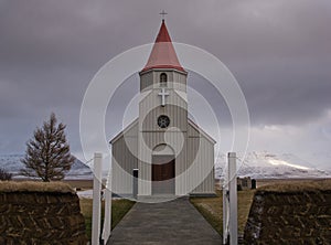 A peat wall in front of a small church in Iceland