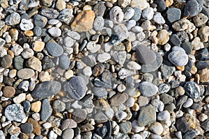Pebble background texture with many pebbles of different sizes and shapes from Fistral beach Newquay