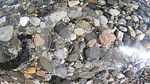 Pebble background under the sea water